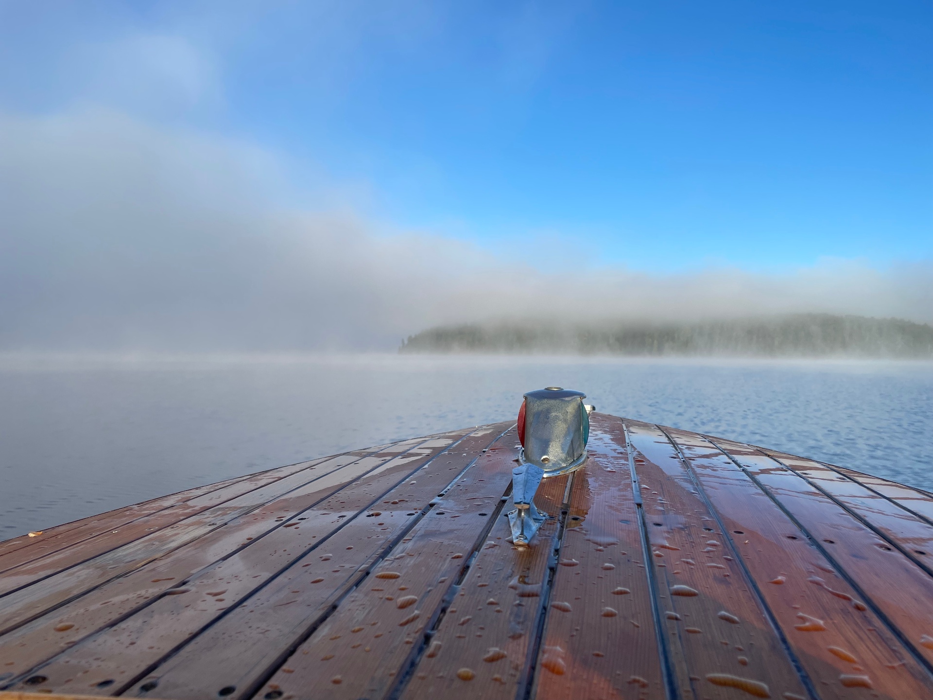 Wooden boat bow on a misty Redstone Lake morning